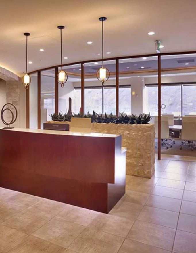 Finished commercial interior with exposed ductwork and architectural lighting